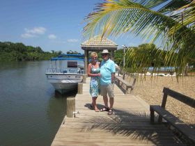 Friends of Howard and Wilana Oldham on a dock in Hopkins Caye, Belize – Best Places In The World To Retire – International Living